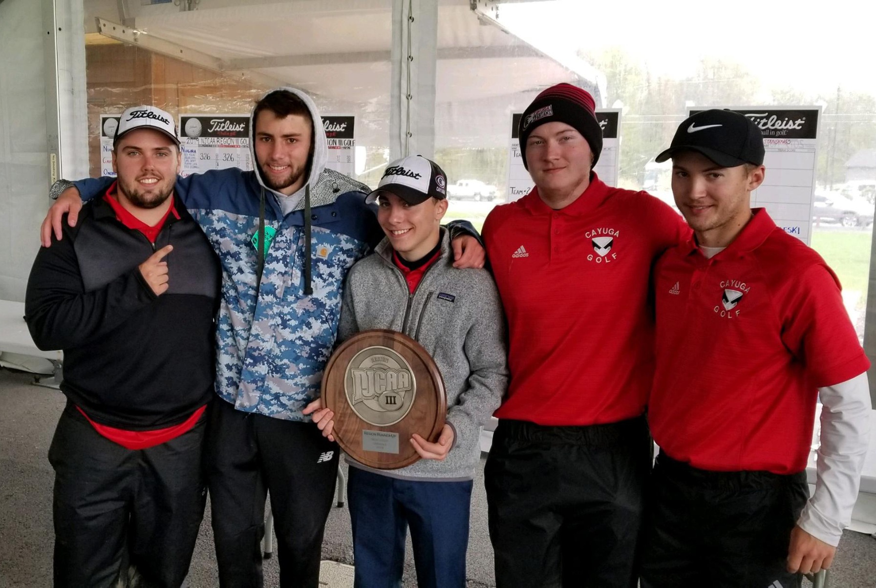 Members of the Cayuga Men's Golf Team proudly display their plaque from the Region III Tournament.