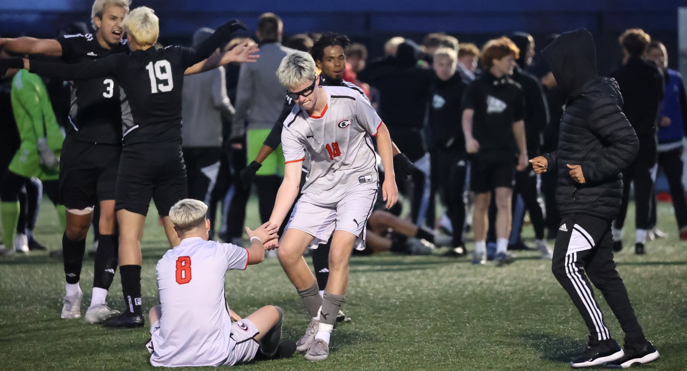 Jake Botterill helps up Charlie Piper after the Spartans lost 2-1 in the regional finals to Mohawk Valley CC. The two accounted for Cayuga's scoring on Sunday, with Piper scoring and Botterill having an assist.